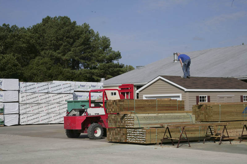 The forklift is ready to pick up this building to load onto a trailer.